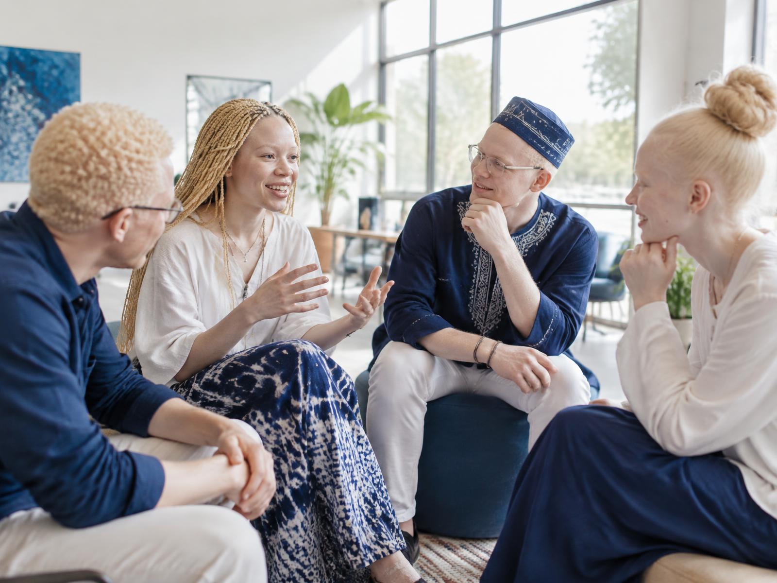 A cross-cultural group of young people with Albinism in conversation